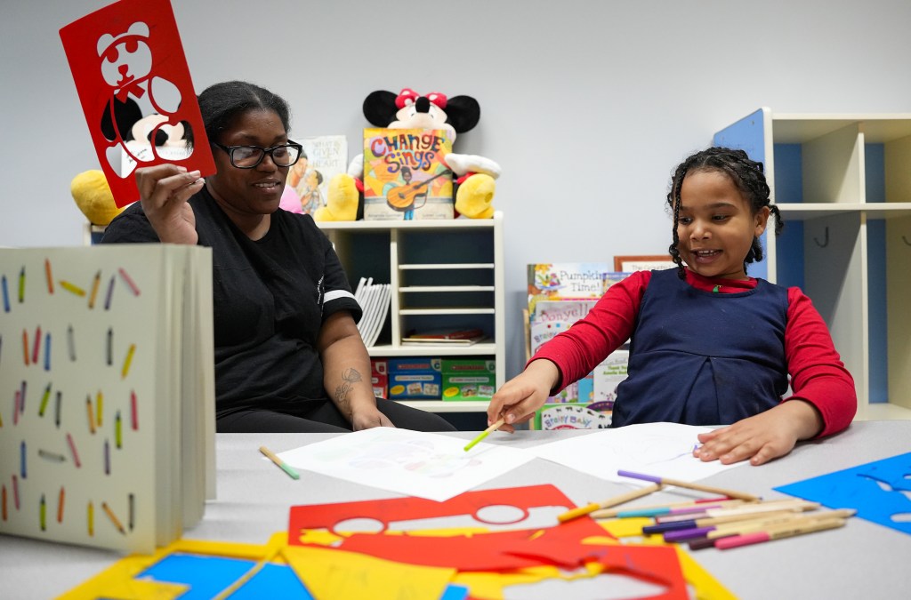Stacey Lewis (left) colors pictures with Darian Quirin, 6, in the care and learning center at Martin University on Monday, Feb. 26, 2024, in Indianapolis. Lewis, a former Martin University student, says she chose to attend Martin because of its free drop-in child care.