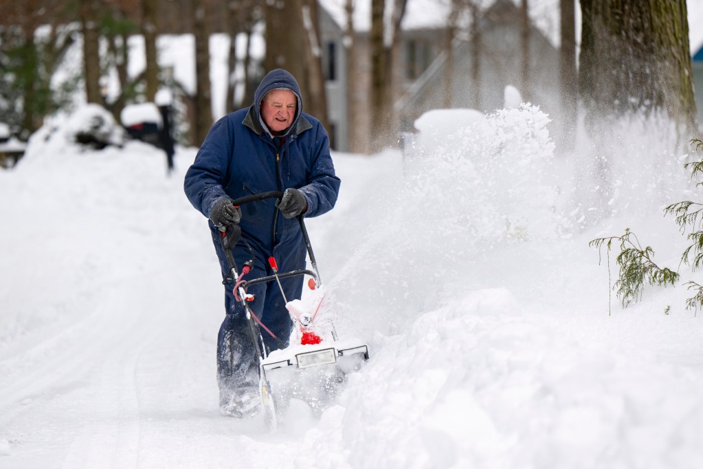 Rocky Beem, of Indianapolis, clears his driveway Jan. 6, 2025, at his home near Eagle Creek. Many in the Indianapolis area were digging their way out of the 6-8 inches of snow that fell on the city overnight.