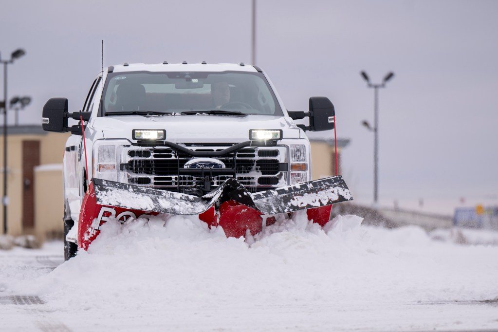 Nate Schauwecker clears snow out of the parking lot of a westside business Jan. 6, 2025. He worked six hours last night on the same lot before returning at 5:30 a.m. to start again. Many in the Indianapolis area were digging their way out of the 6-8 inches of snow that fell on the city overnight.