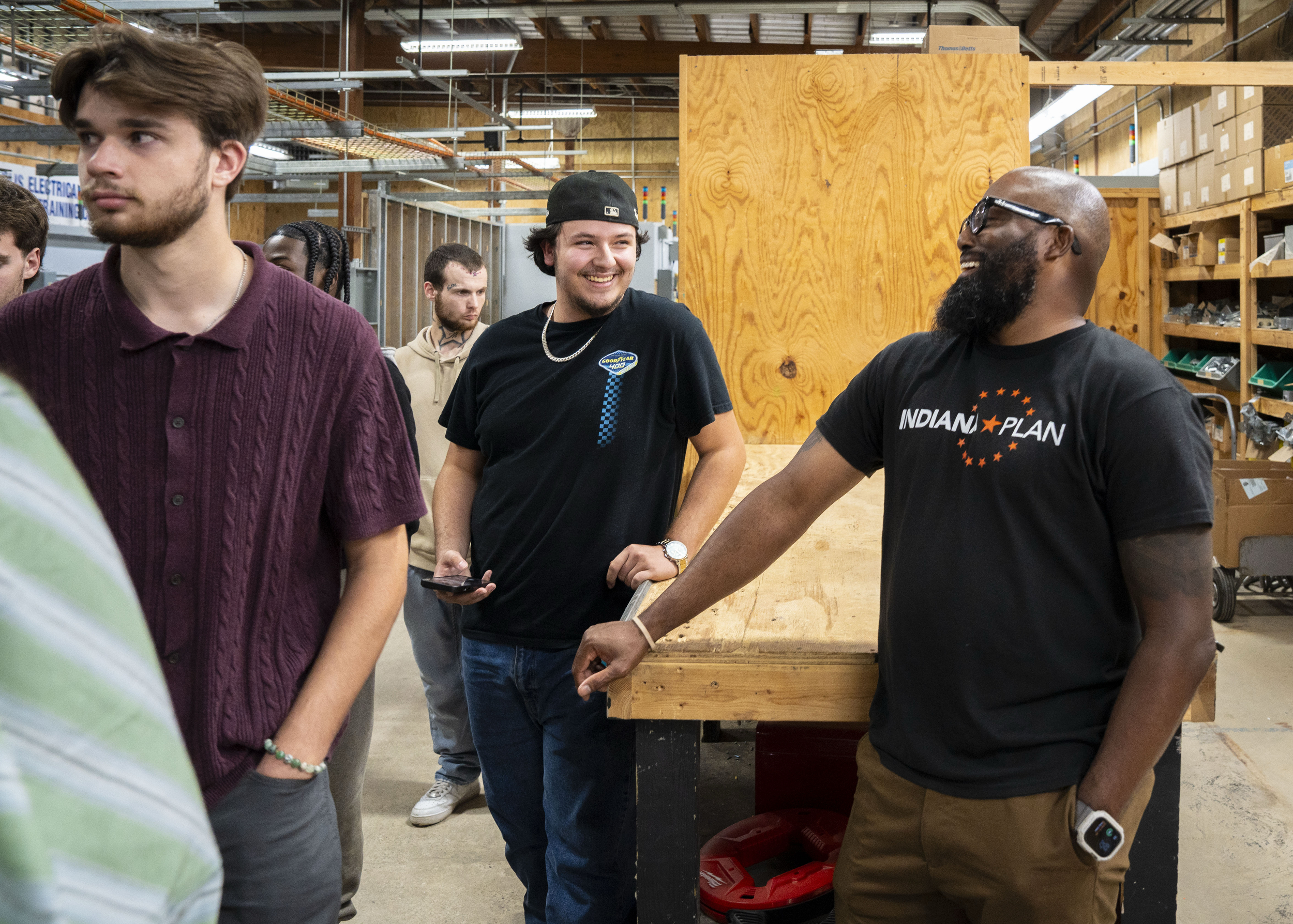 Indiana Plan student Jianni Murilo (center) and Indiana Plan executive director Devon Doss (right) laugh while touring the Electrical Training Institute on Sept. 23, 2025, in Indianapolis.