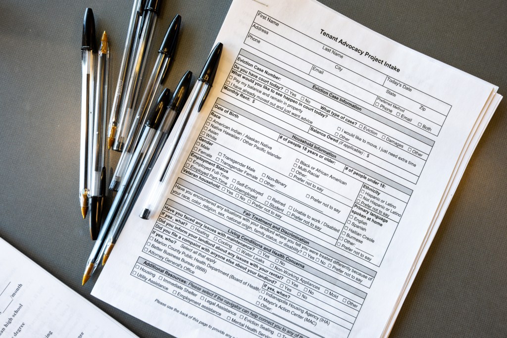 People meet with court navigators ahead of their proceedings at the Wayne Township Small Claims Court in Indianapolis on Dec. 4, 2025. The navigators work as part of the city’s Tenant Advocacy Project, which provides free legal representation to residents facing eviction. The navigator team — non-attorneys who serve as the first point of contact for people in court — is scheduled to be dissolved at the end of the year as the city merges services with a similar program run by Lawrence Township’s court.