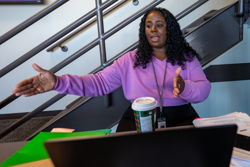 Camille Kelly, a navigator for the city’s Tenant Advocacy Project, talks while working at her computer as people meet with court navigators ahead of their proceedings at the Wayne Township Small Claims Court in Indianapolis on Dec. 4, 2025. The navigators provide free legal representation to residents facing eviction. The navigator team — non-attorneys who serve as the first point of contact for people in court — is scheduled to be dissolved at the end of the year as the city merges services with a similar program run by Lawrence Township’s court.