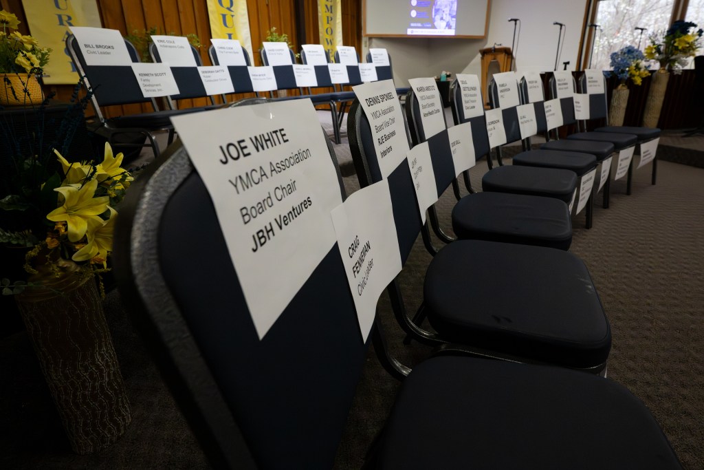 The names of the Board of Directors for the YMCA of Greater Indianapolis hold a place for each member at a town hall on the closure of the Ransburg YMCA March 26, 2026, at Amazing Grace Christian Church. No board members were in attendance.
