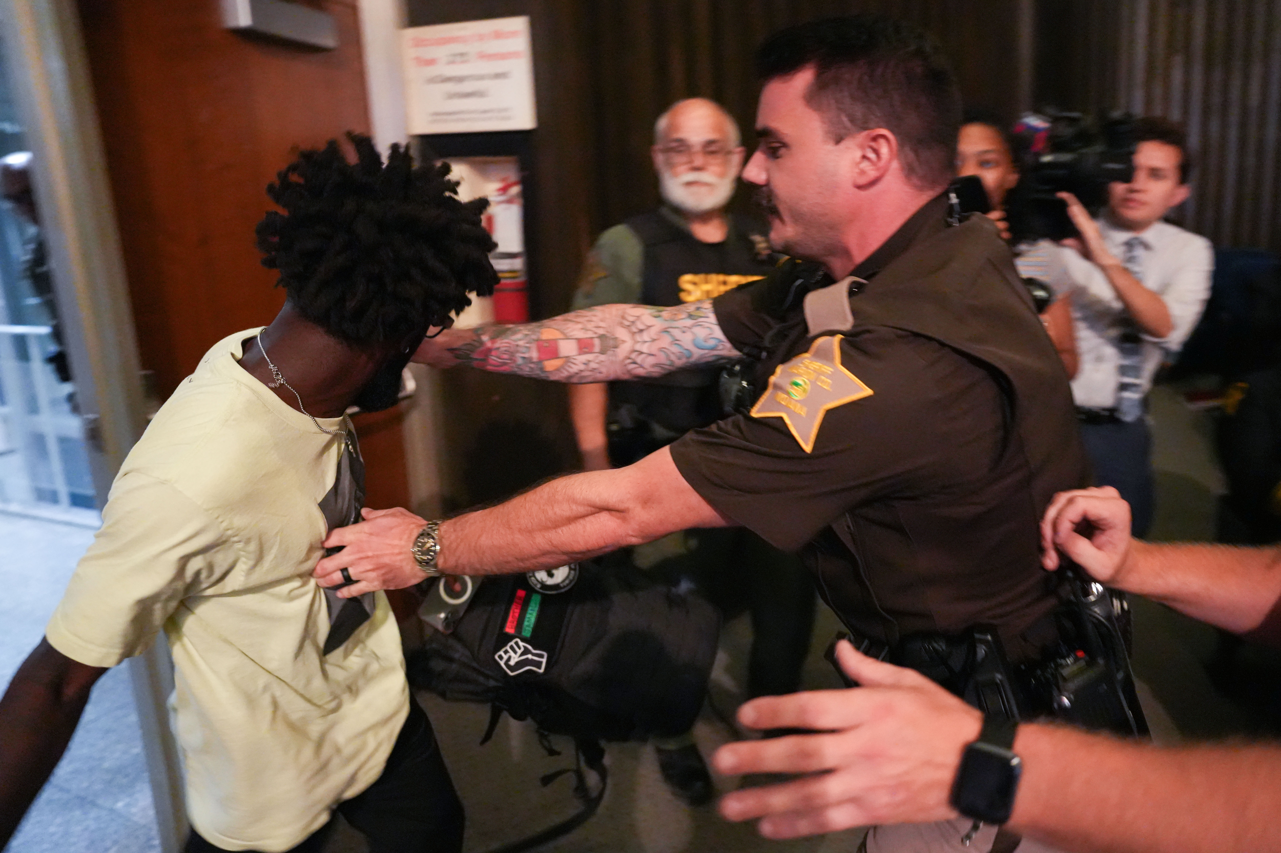 Sheriff deputy handcuffs protester during emotional IMPD hearing